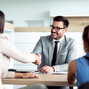 Man in glasses and suit shaking hands
