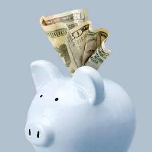 Piggy pank with $20 bill stuffed in it